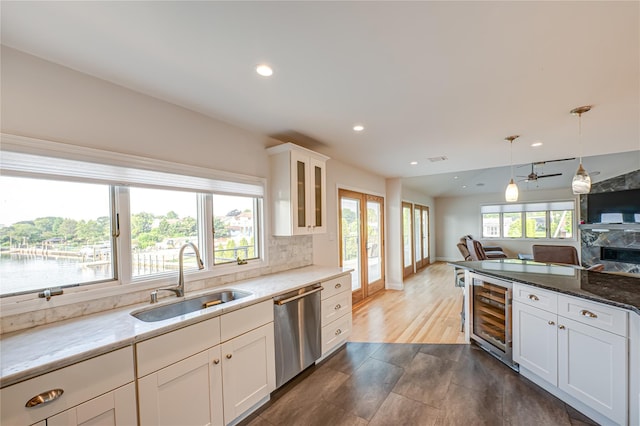 714 Montauk, West Islip, NY 11795 - kitchen featuring beverage cooler, dishwasher, open floor plan, glass insert cabinets, and decorative light fixtures