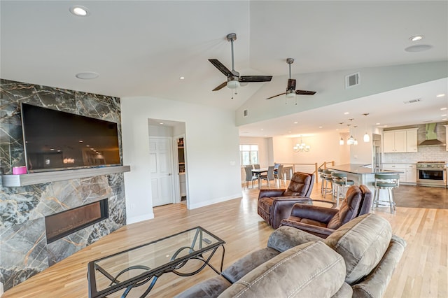714 Montauk, West Islip, NY 11795 - living area featuring a fireplace, light wood-style flooring, ceiling fan, recessed lighting, and a chandelier