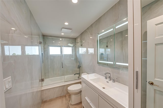 714 Montauk, West Islip, NY 11795 - full bath featuring shower / bath combination with glass door, vanity, recessed lighting, and tile walls