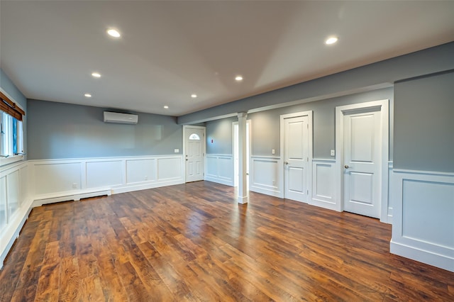 714 Montauk, West Islip, NY 11795 - basement with an AC wall unit, recessed lighting, a wainscoted wall, a decorative wall, and wood finished floors