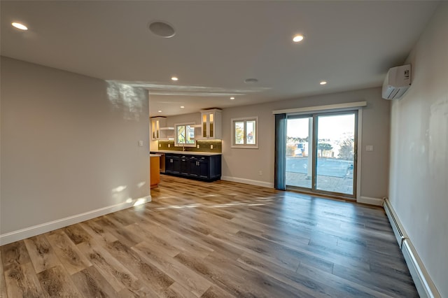 714 Montauk, West Islip, NY 11795 - unfurnished living room featuring a wall unit AC, light wood-type flooring, and recessed lighting