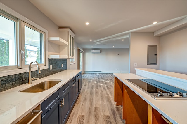 714 Montauk, West Islip, NY 11795 - kitchen featuring electric panel, black electric cooktop, a wall unit AC, light wood-style floors, and backsplash