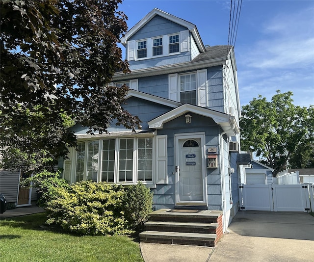 40 Syracuse St, Williston Park, NY 11596 - american foursquare style home featuring a gate and concrete driveway