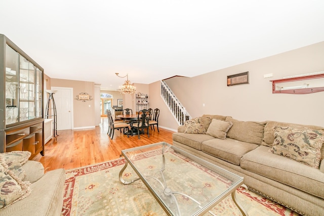 40 Syracuse St, Williston Park, NY 11596 - living area with a chandelier, healthy amount of natural light, wood finished floors, and stairs