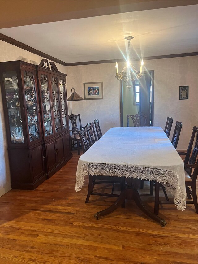 319 Mill Rd, Hewlett, NY 11557 - dining area with wood finished floors, a chandelier, and ornamental molding