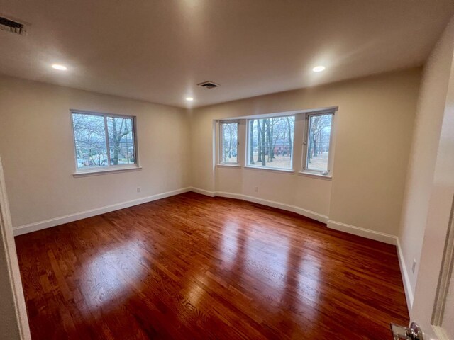 3245 210th St, Bayside, NY 11361 - spare room with plenty of natural light, wood finished floors, and recessed lighting