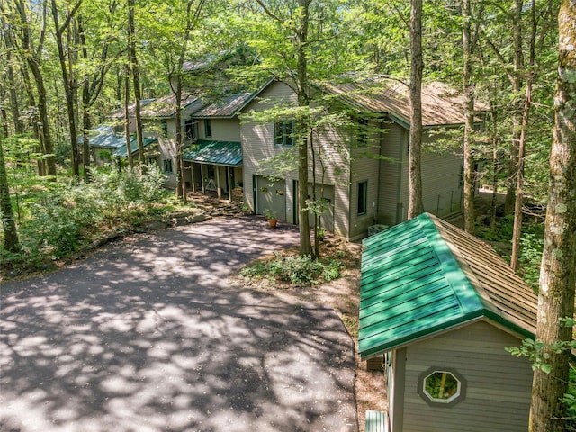 15 Cox Dr, Warwick, NY 10950 - view of front of house with asphalt driveway, an attached garage, and a metal roof