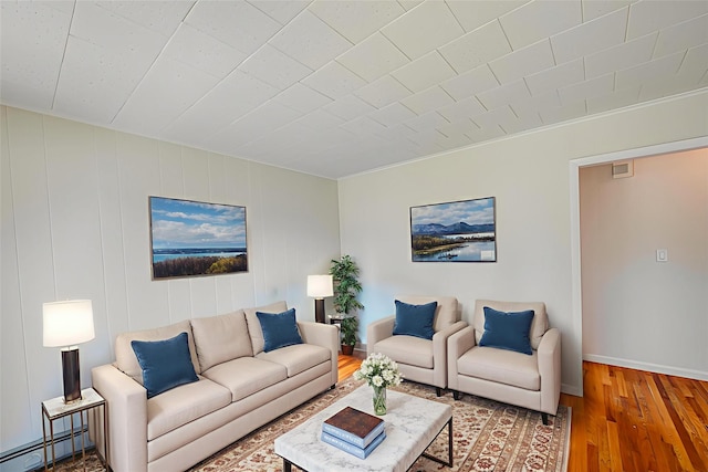926 9th St, West Babylon, NY 11704 - living area featuring a baseboard radiator and wood-type flooring