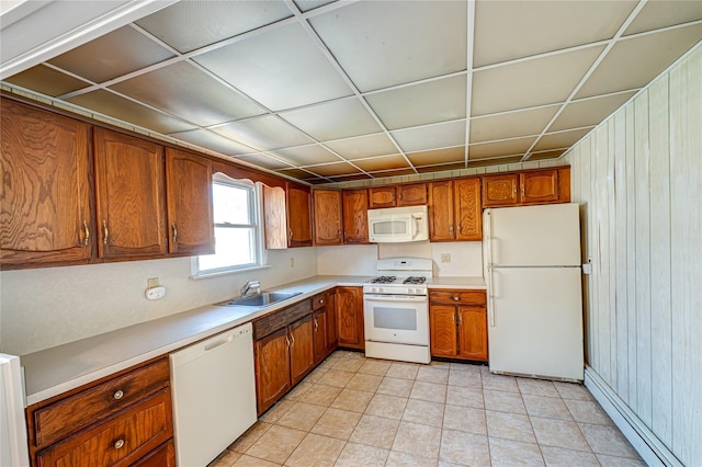 926 9th St, West Babylon, NY 11704 - kitchen with white appliances, a baseboard heating unit, brown cabinetry, and light countertops