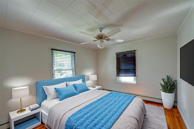 926 9th St, West Babylon, NY 11704 - bedroom featuring ornamental molding, wood finished floors, and ceiling fan