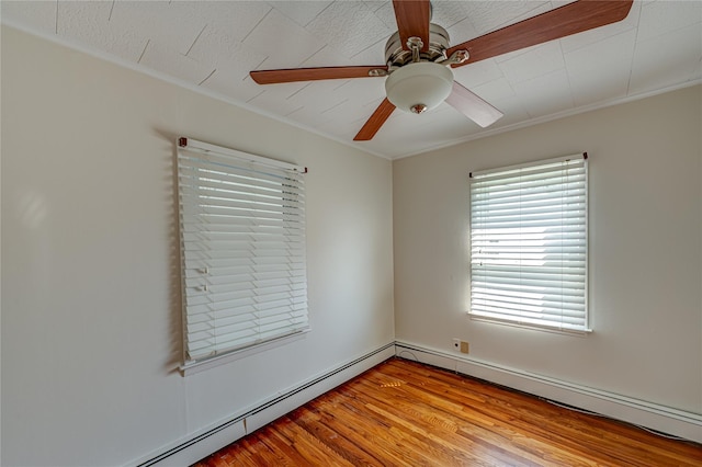 926 9th St, West Babylon, NY 11704 - spare room featuring a baseboard heating unit, ceiling fan, crown molding, and wood finished floors