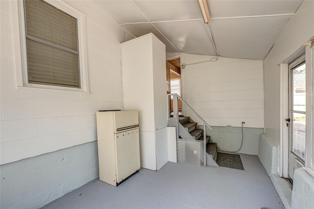 926 9th St, West Babylon, NY 11704 - below grade area with freestanding refrigerator, stairs, and concrete block wall