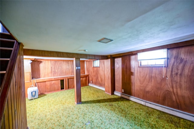 926 9th St, West Babylon, NY 11704 - basement with a baseboard heating unit, carpet, and wooden walls