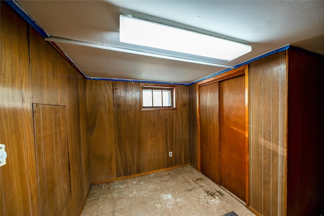 926 9th St, West Babylon, NY 11704 - below grade area featuring wood walls and light flooring