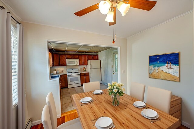 926 9th St, West Babylon, NY 11704 - dining area with a baseboard radiator, a ceiling fan, ornamental molding, and light tile patterned flooring