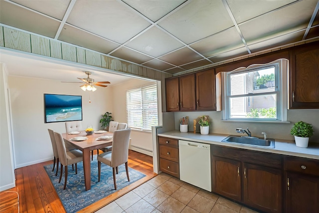 926 9th St, West Babylon, NY 11704 - kitchen featuring dishwasher, light countertops, baseboard heating, and plenty of natural light