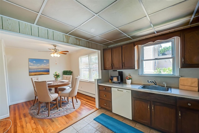 926 9th St, West Babylon, NY 11704 - kitchen with white dishwasher, a baseboard heating unit, light countertops, and healthy amount of natural light