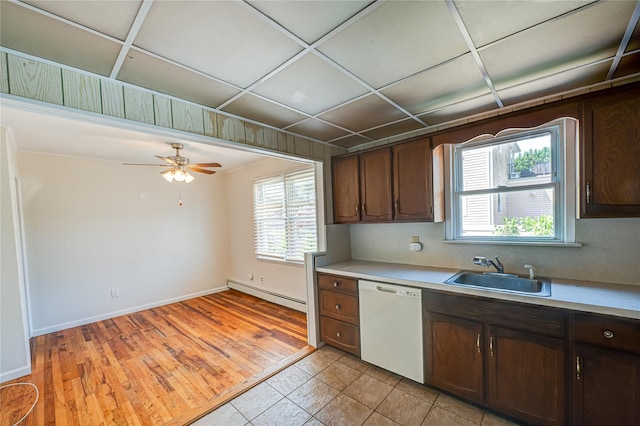926 9th St, West Babylon, NY 11704 - kitchen featuring white dishwasher, a baseboard radiator, plenty of natural light, and light countertops