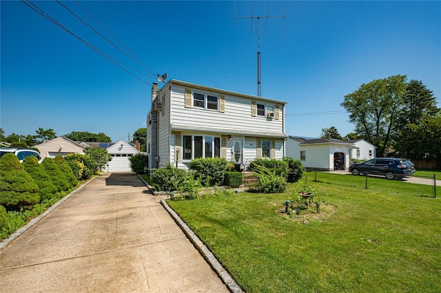 926 9th St, West Babylon, NY 11704 - colonial house featuring a chimney and a detached garage