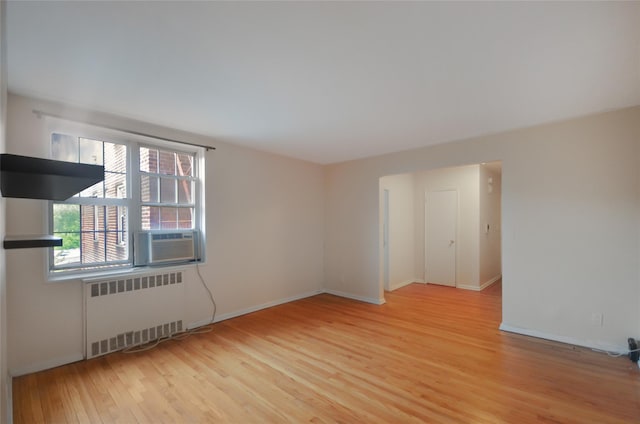 790 Bronx River Rd Unit A31, Bronxville, NY 10708 - spare room featuring radiator heating unit, wood finished floors, and cooling unit