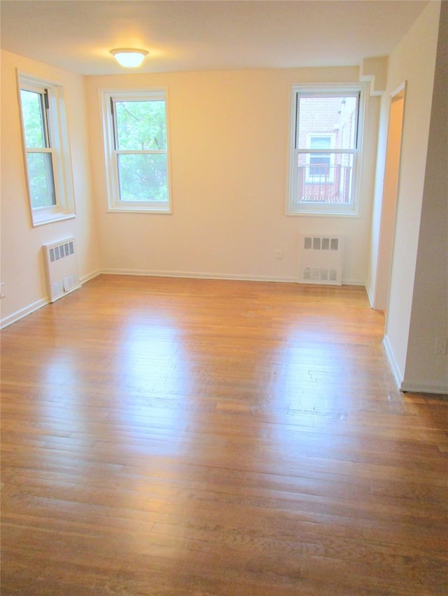 76 Dehaven Dr Unit 6B, Yonkers, NY 10703 - spare room with radiator heating unit and wood finished floors