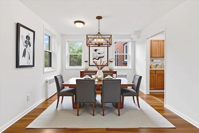 76 Dehaven Dr Unit 6B, Yonkers, NY 10703 - dining space with a chandelier, radiator, and dark wood finished floors