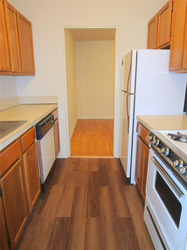 76 Dehaven Dr Unit 6B, Yonkers, NY 10703 - kitchen with white appliances, dark wood-style floors, light countertops, and brown cabinets