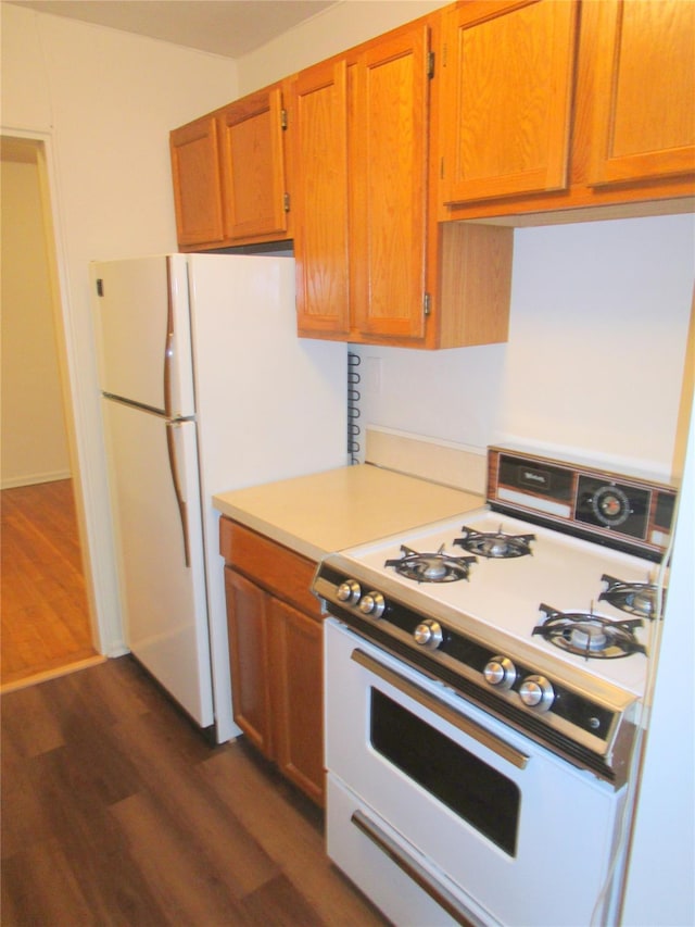 76 Dehaven Dr Unit 6B, Yonkers, NY 10703 - kitchen featuring white appliances, dark wood finished floors, light countertops, and brown cabinetry