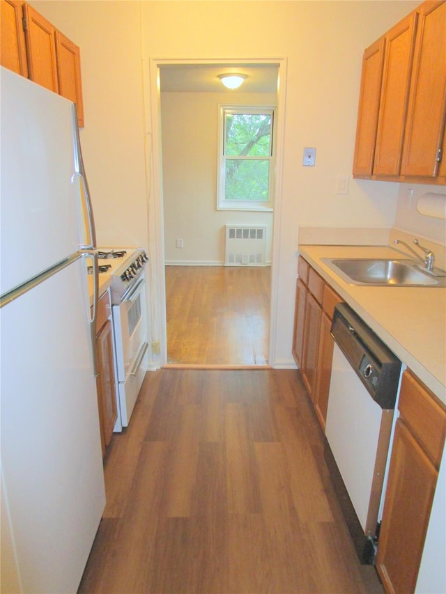 76 Dehaven Dr Unit 6B, Yonkers, NY 10703 - kitchen featuring white appliances, dark wood finished floors, radiator, light countertops, and brown cabinetry