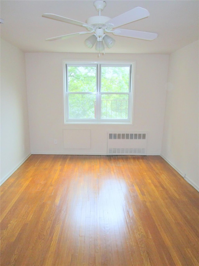 76 Dehaven Dr Unit 6B, Yonkers, NY 10703 - empty room featuring radiator heating unit, light wood-style flooring, and a ceiling fan