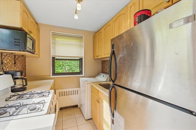 199-44 19th Ave Unit 1-34, Whitestone, NY 11357 - kitchen with freestanding refrigerator, radiator heating unit, white gas range oven, black microwave, and light brown cabinets
