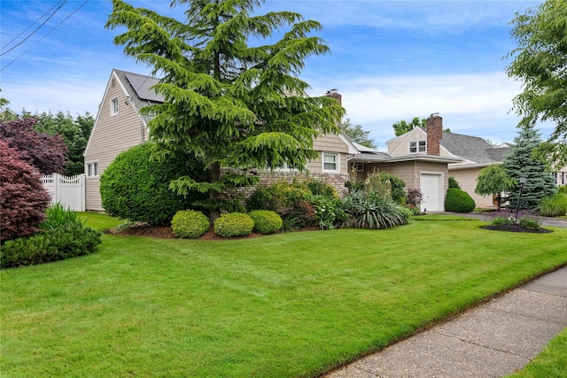 10 Cail Dr, East Rockaway, NY 11518 - obstructed view of property featuring a chimney and a garage