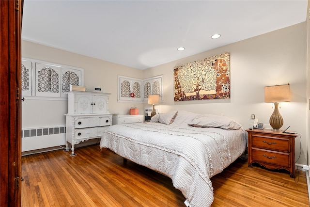 10 Cail Dr, East Rockaway, NY 11518 - bedroom with radiator, wood-type flooring, and recessed lighting