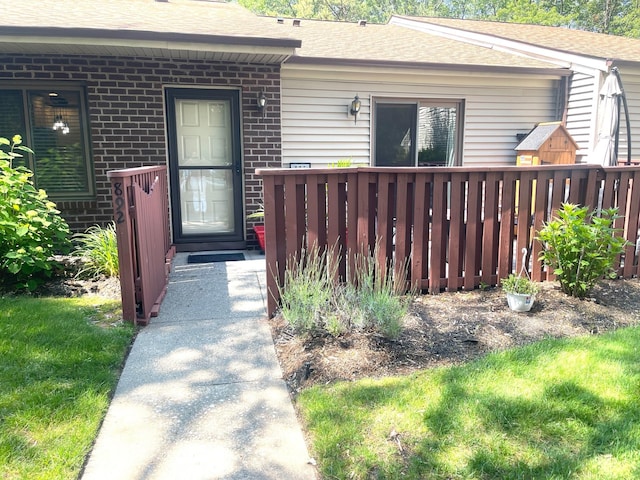 892 Skyline Dr Unit 892, Coram, NY 11727 - doorway to property featuring roof with shingles and brick siding