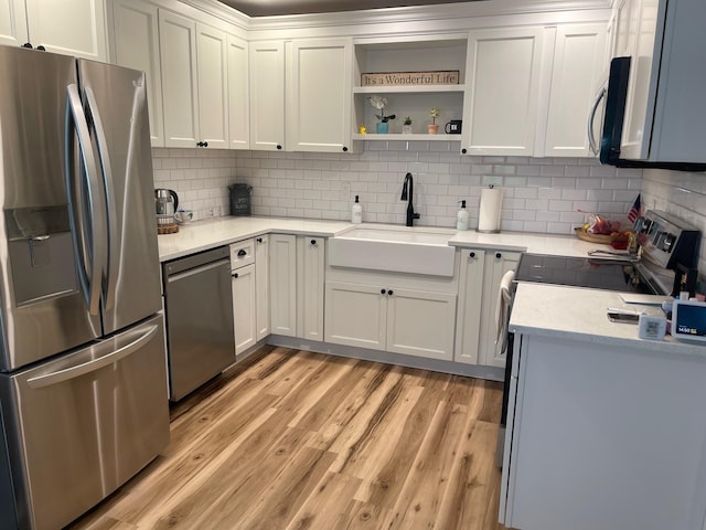892 Skyline Dr Unit 892, Coram, NY 11727 - kitchen with appliances with stainless steel finishes, light wood finished floors, decorative backsplash, light countertops, and open shelves