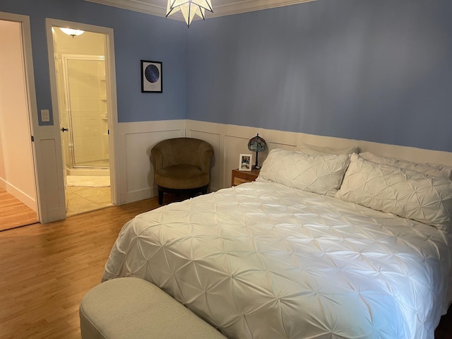 892 Skyline Dr Unit 892, Coram, NY 11727 - bedroom featuring wood finished floors, ornamental molding, connected bathroom, and wainscoting