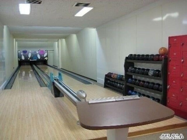 892 Skyline Dr Unit 892, Coram, NY 11727 - playroom with a bowling alley and wood finished floors