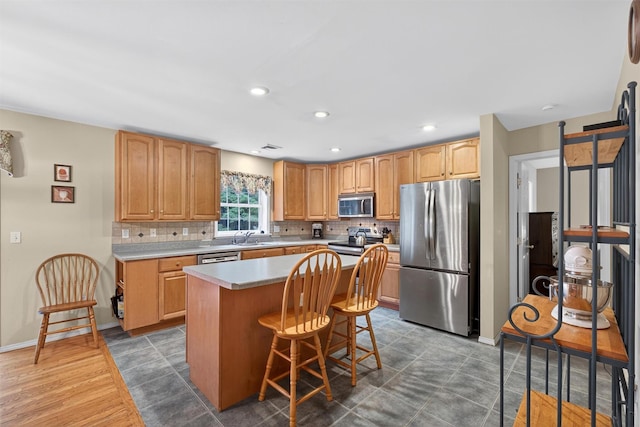 114 Bushwick Rd, Poughkeepsie, NY 12603 - kitchen with appliances with stainless steel finishes, decorative backsplash, light countertops, a kitchen island, and recessed lighting