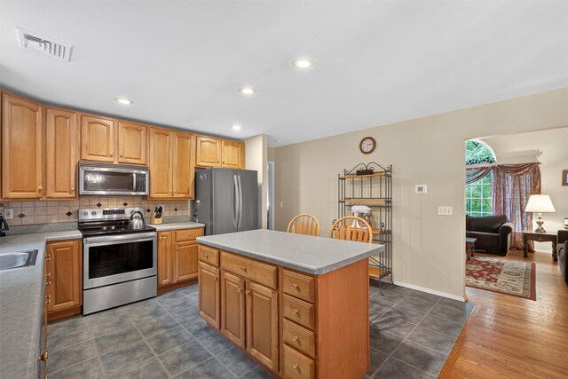 114 Bushwick Rd, Poughkeepsie, NY 12603 - kitchen with appliances with stainless steel finishes, backsplash, a center island, light countertops, and recessed lighting
