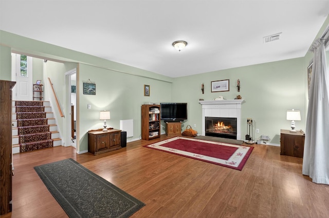 114 Bushwick Rd, Poughkeepsie, NY 12603 - living room featuring a fireplace, wood finished floors, and stairs