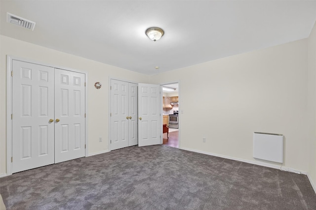114 Bushwick Rd, Poughkeepsie, NY 12603 - unfurnished bedroom featuring two closets and dark colored carpet