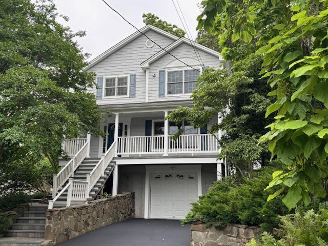 24 Midland Ave, Port Jefferson, NY 11777 - view of front facade featuring stairway, a porch, a garage, and driveway
