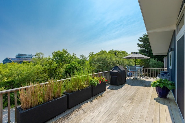66 Hawser Dr, Oak Beach, NY 11702 - wooden terrace with outdoor dining space and a grill