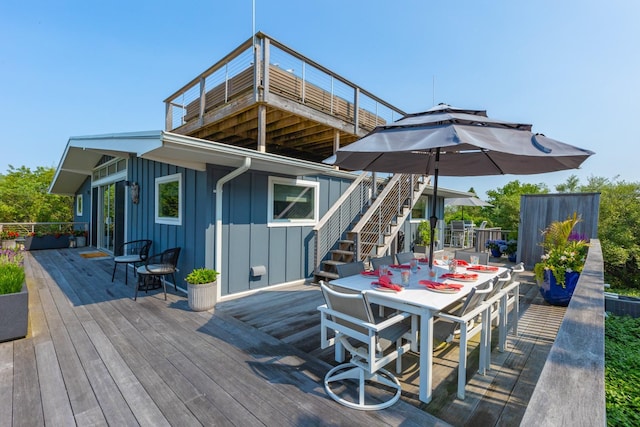 66 Hawser Dr, Oak Beach, NY 11702 - wooden terrace with outdoor dining space and stairway