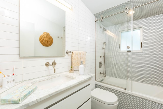 66 Hawser Dr, Oak Beach, NY 11702 - bathroom featuring tiled shower / bath combo, vanity, tile walls, and decorative backsplash
