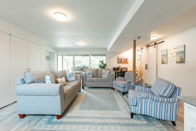 66 Hawser Dr, Oak Beach, NY 11702 - living room featuring a barn door and light wood-style floors