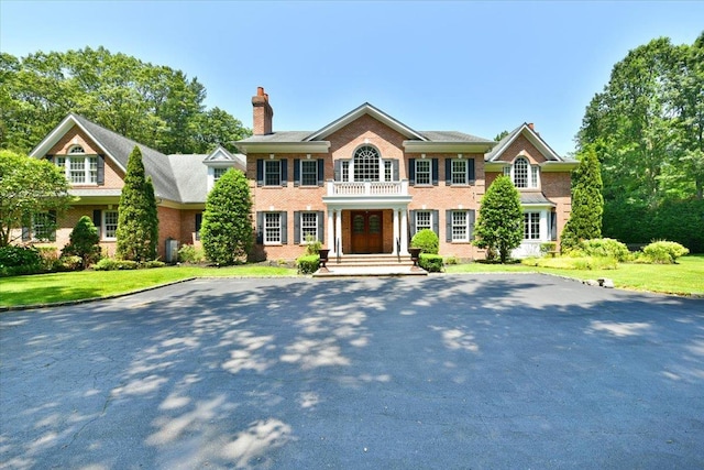 1616 Stewart Ln, Laurel Hollow, NY 11791 - colonial home featuring brick siding and a chimney