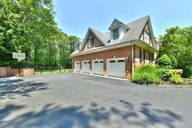 1616 Stewart Ln, Laurel Hollow, NY 11791 - view of home's exterior with brick siding, driveway, and a garage