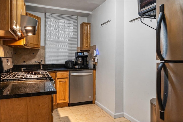 7817 Park Dr E Unit 1St, Kew Garden Hills, NY 11367 - kitchen featuring appliances with stainless steel finishes, decorative backsplash, brown cabinets, ventilation hood, and dark stone countertops