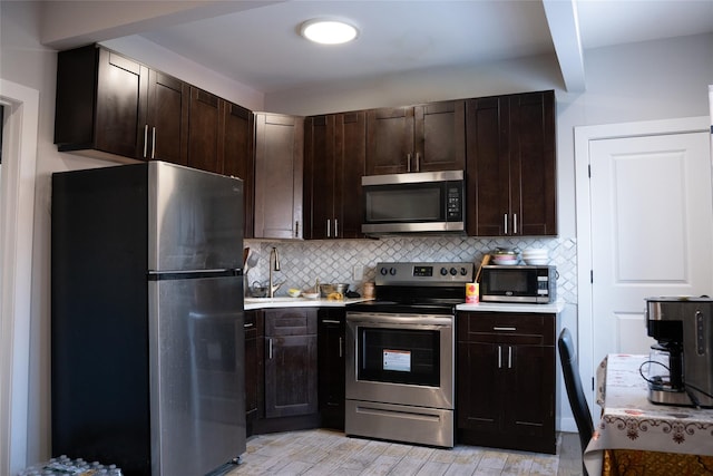 1602 Zerega Ave, Bronx, NY 10462 - kitchen featuring appliances with stainless steel finishes, backsplash, dark brown cabinets, light countertops, and light wood finished floors